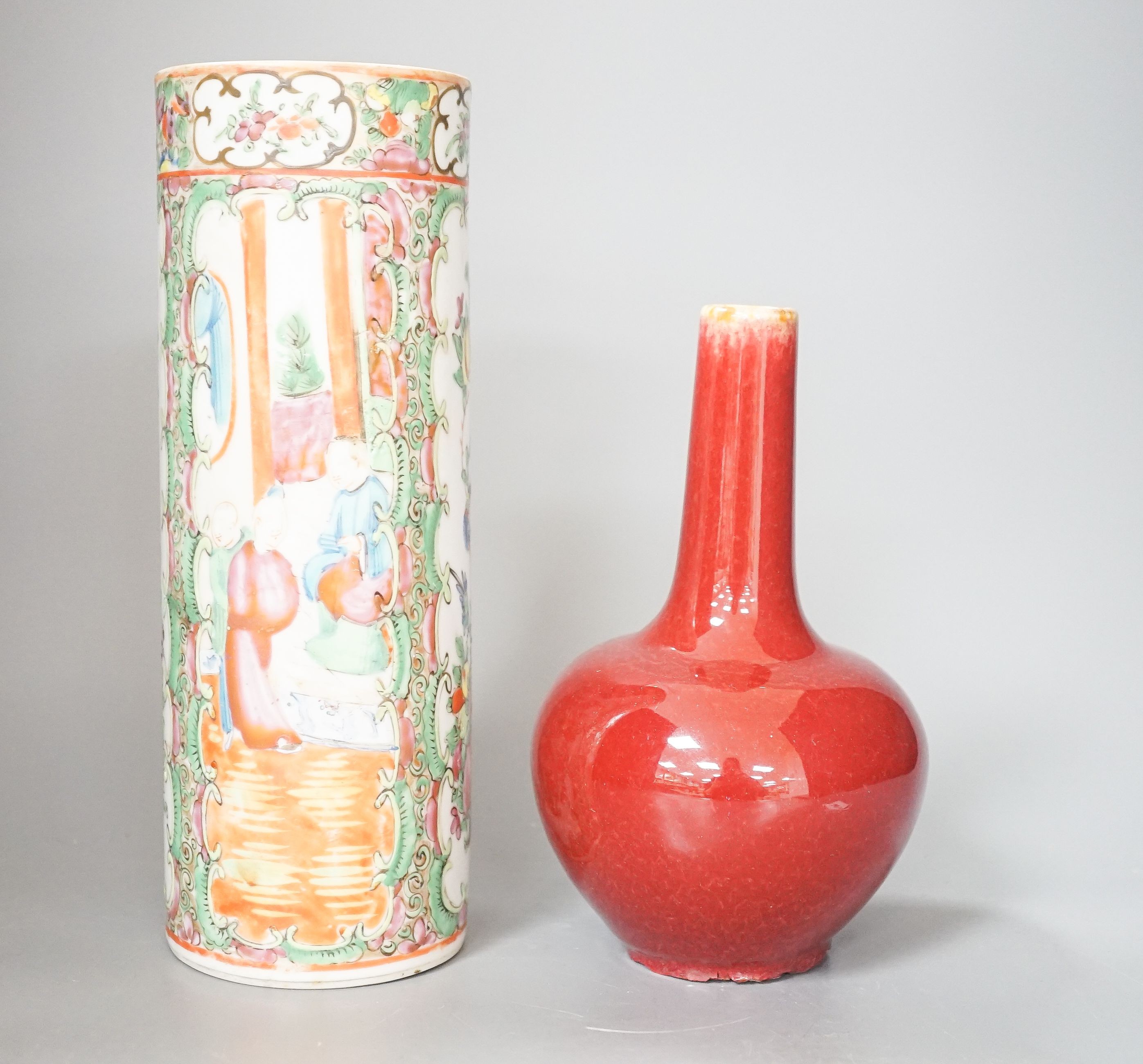A Chinese famille rose cylindrical vase and a flambé bottle vase vase, tallest 24 cm